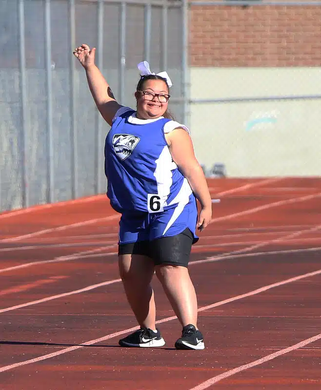 Special Olympics Colorado athlete waving while on track.