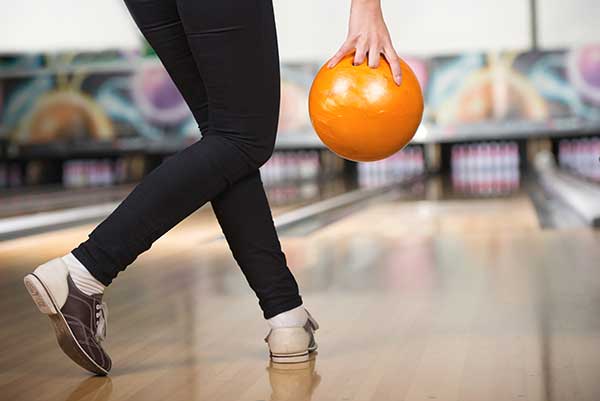 Person with bowling ball at bowling lane
