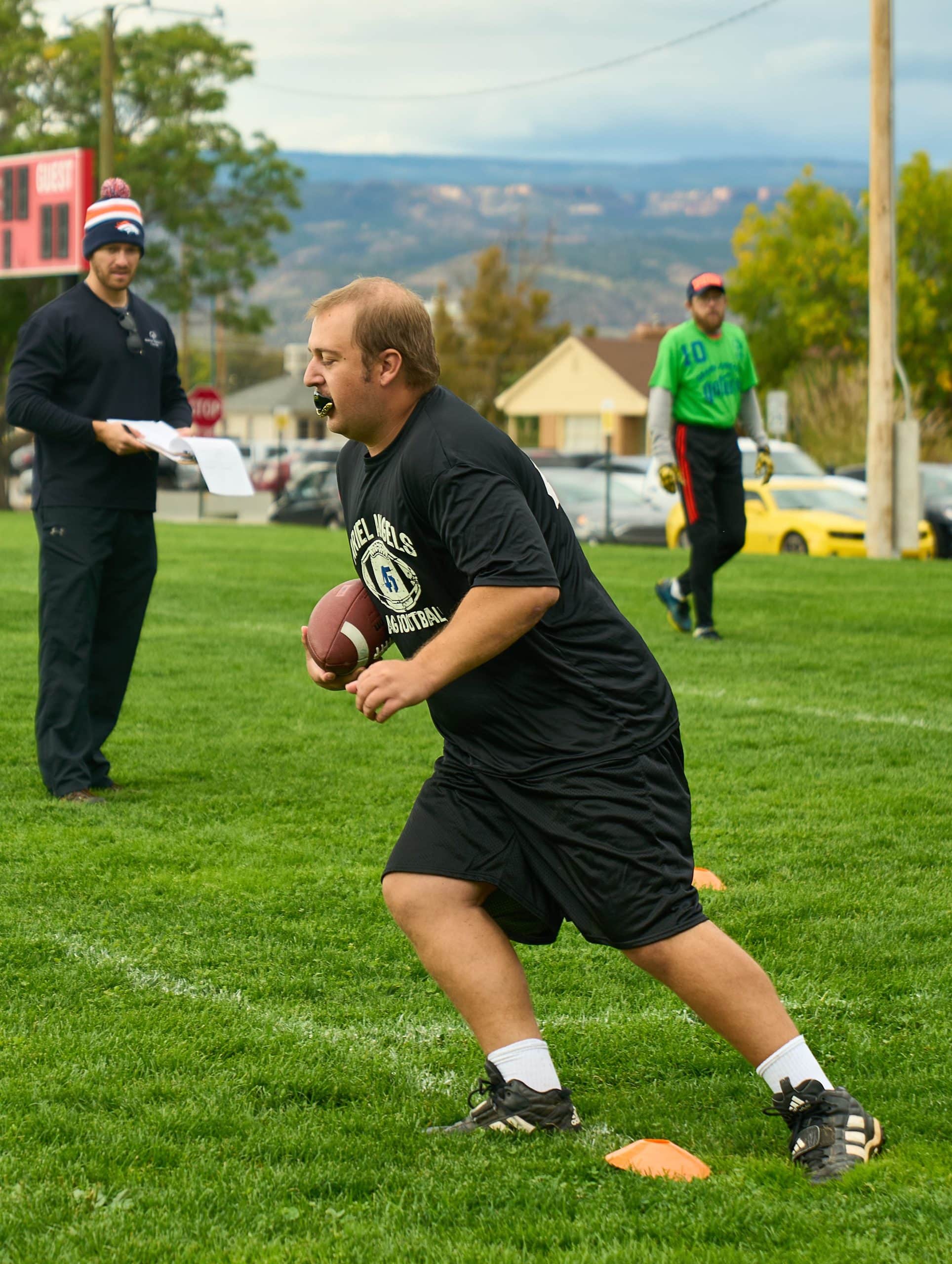 Picture of athlete Case Collard running with a football in his hands.