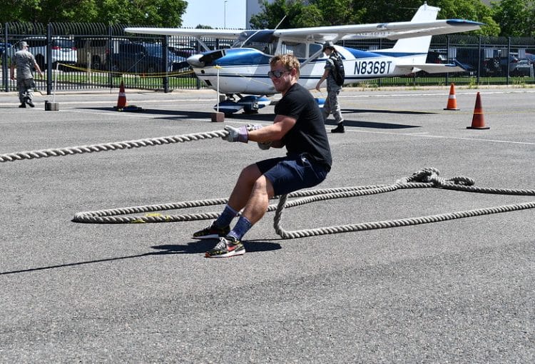 Photo of individual pulling a plane at plane pull