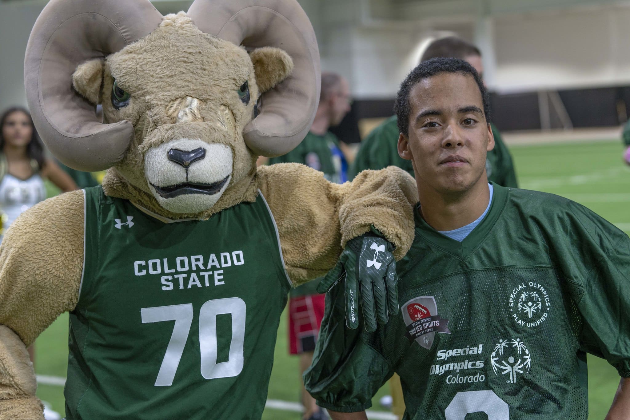 Photo of unified football player and mascot