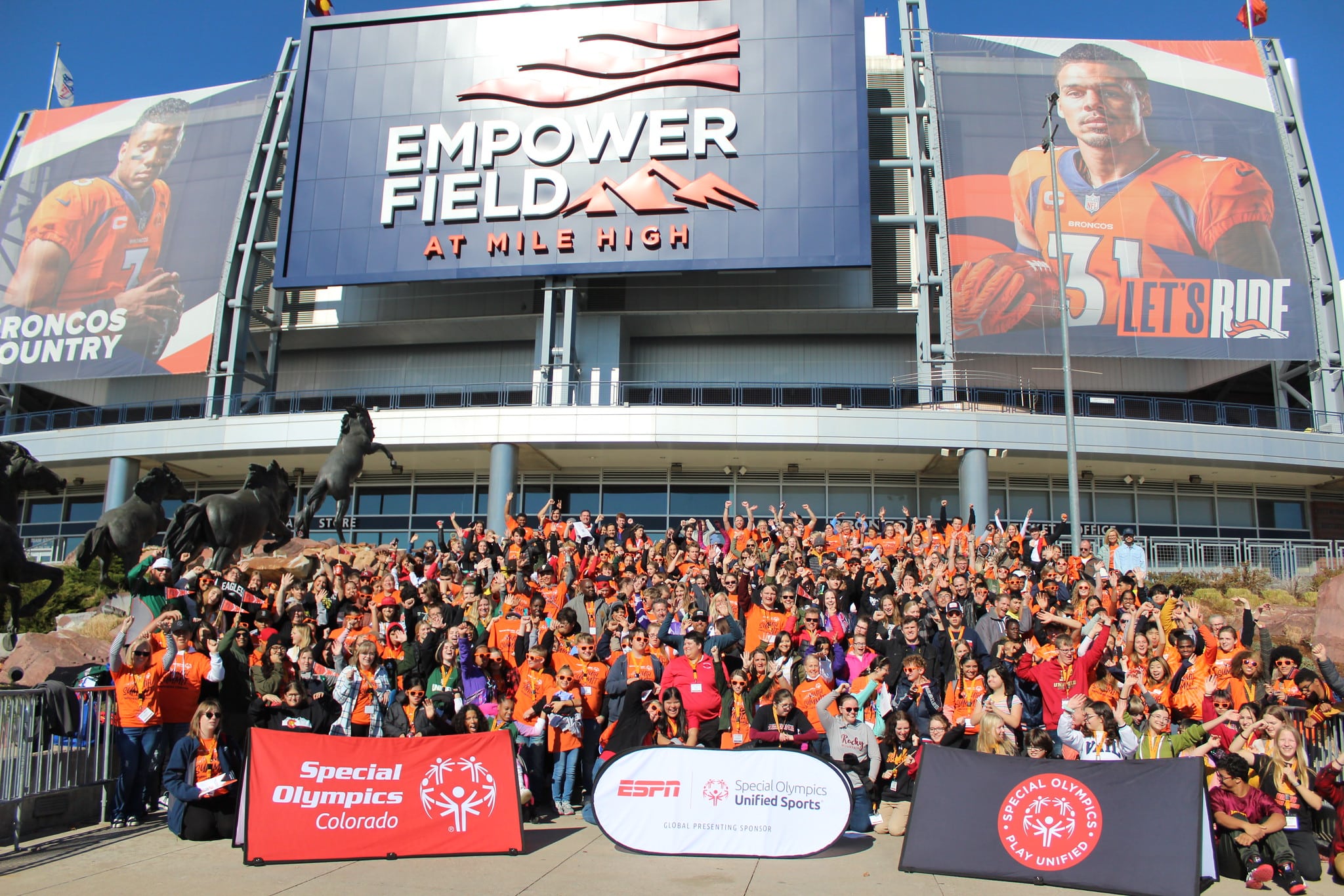 Group shot of crowd in front of Empower Field at Youth Summit