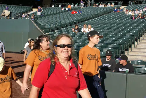 Forrest Phillips smiling in a stadium in a special olympics colorado red polo