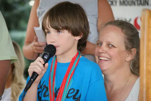 Forrest Phillips with young athlete holding a microphone