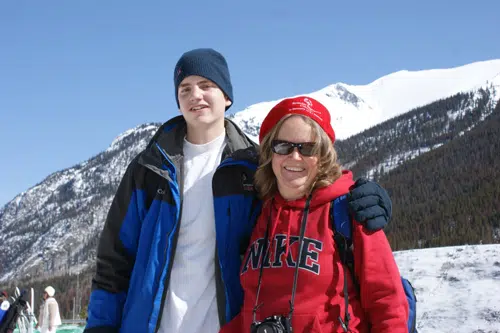 Forrest Phillips with an athlete on a snowy mountain