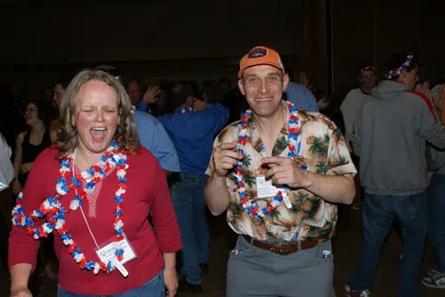 Forrest Phillips with athlete wearing leis at a celebration